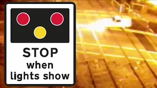 Caught on CCTV: Yellow three-wheeled van crashes through level crossing in reverse