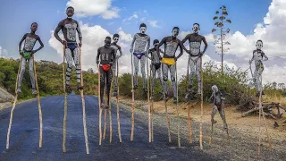 Banna tribe boys walking on stilts Omo Valley Ethiopia