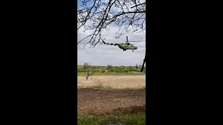 A pair of extremely low-flying Mi-8 Ukraine helicopters mow the grass on Ukraine's front lines