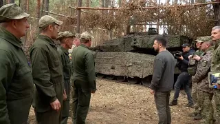 Zelenskiy inspects Leopard 2 tank, Swedish armoured vehicle in front line