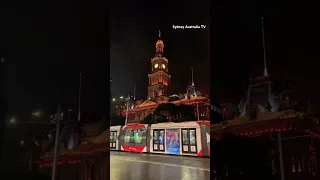 NIGHT VIEW OF SYDNEY TOWN HALL, A HERITAGE-LISTED BUILDING IN THE CITY OF SYDNEY AUSTRALIA.