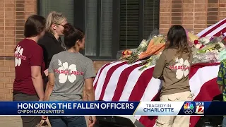 Charlotte community members bring flowers at memorial sites to honor fallen officers