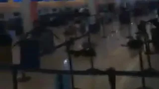 Panic at Cancun Airport in Mexico, people running & screaming as they heard gunfire-like sound.