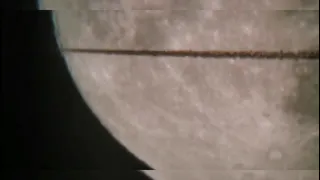 An airplane flies over the moon