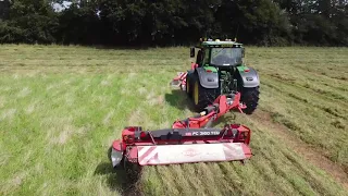 John Deere 6250 R with a duo of mowers front and back completing haylage 3rd cut