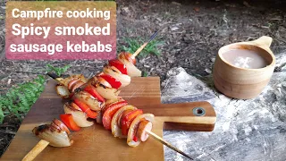 Campfire cooking. Spicy smoked sausage kebabs on the Bitty Big Q grill. Wild camping Scotland.