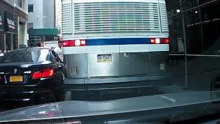Bus slowly destroys double-parked BMW's mirror