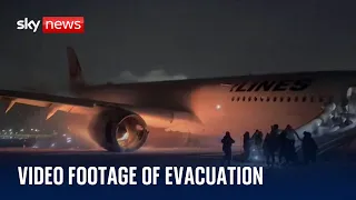 New footage of passengers evacuating burning plane in Japan