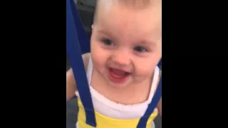 Baby Avaya laughing in her swing