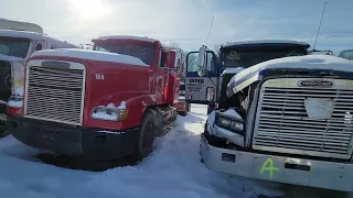 walking through a semi truck salvage yard