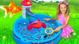 Sasha catches fish with fishing water toys