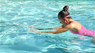 Karolina Protsenko is taking swimming lessons in the pool