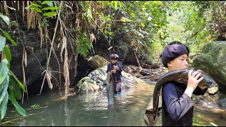 Little boy Phu caught a 3kg catfish in a wild stream.