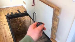 Guy uses a homemade remote controlled door opener to open his secret hidden basement door