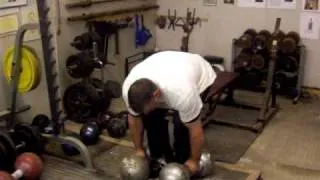 Laine Snook- deadlifting two Millennium Dumbbells - first man in History to do this.