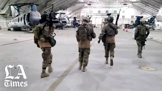 Taliban fighters enter what was the U.S.-controlled portion of the Kabul airport.