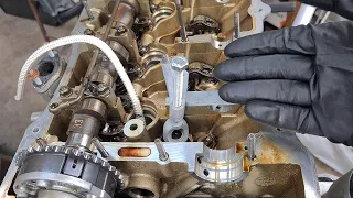 Using rope to hold valves during valve spring removal and valve stem seal replacement