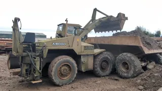 civil engineering 1970 style! moving big pile of rubble to make new access road with old loader