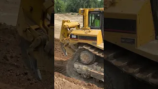 Caterpillar D8R feeds gravel to rock crusher