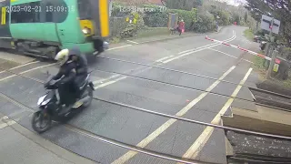 WHOA: Moped riders nearly struck by train after running red light in England