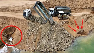 Oh God, Dump Truck Working Hard To Unloading Crushed Stone To Fill Deep Water By Komatsu D31A Dozer