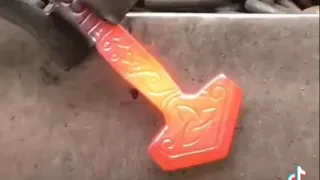 Blacksmith forging a Mjölnir (Thor’s hammer) pendant