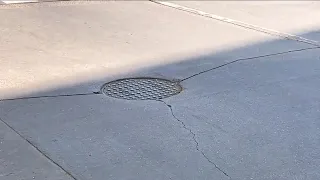 Driving You Crazy: Why do some streets have manhole covers right in the path of your tires?