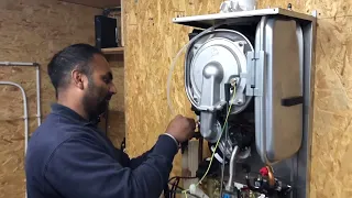 ACS Gas Training - Trainee Plumber Looking At The Components Inside A Gas Boiler