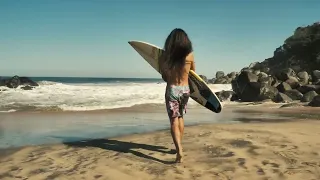 surfer running on the beach