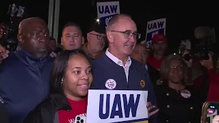 UAW President Shawn Fain marches with striking workers