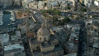 Majestic Beautiful Brown Catholic Church in Msida Town, Malta from Aerial Drone perspective