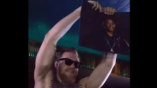 Conor McGregor bouncing on top of a packed bar in Rio de jeneiro and ripping up a photo of Jose Aldo