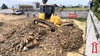 Excellent work! Rocky soils Pushing by Komatsu Bulldozer Landfill connections to wall with DumpTruck