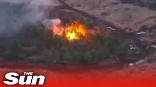 Ukrainian soldiers blow up camouflaged Russian ammo depot in forest