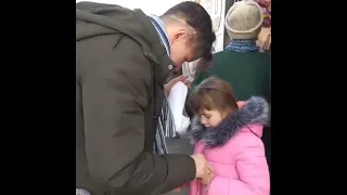 Ukrainian father says goodbye to his daughter as he stays behind to fight against Russia