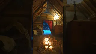 open fire inside my permanent bushcraft shelter on a cold winter evening