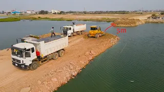 Wonderful Making Nice Road on Water with Bulldozer SHANTUI Spreading Stone and Truck Unloading Stone