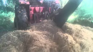 International 674 splitting a bale