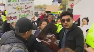 Crowd protesting migrant camp plan swarm Chicago alderwoman, aide