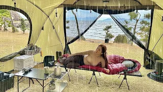 Soaked girl camping in a big tent in the rain on the beach  ASMR