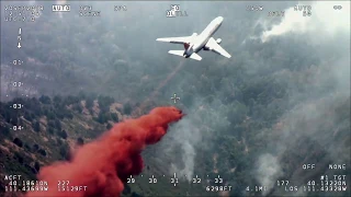 Very Large Air Tanker, a DC-10, drops retardant on Pole Creek Fire