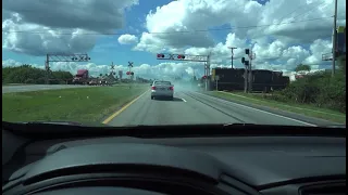 IDIOT NEARLY HIT BY CSX TRAIN Car crashes through Crossing Gate! Distracted by Phone!