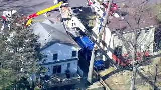 Large crane collapsed, tangled in power wires in NJ