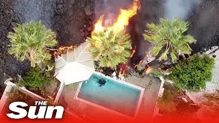 La Palma eruption – Drone shots shows lava swallowing swimming pools & homes as thousands flee