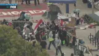 Brief confrontation between man carrying USA flag, pro-Palestine demonstrators at UC Irvine