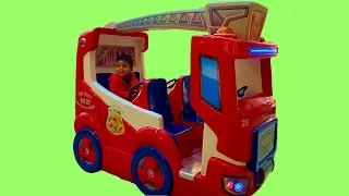 Little boy playing on fire truck ride on car