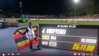 Joshua Cheptegei waves a Ugandan national flag as he celebrates after breaking the world 10000m REC