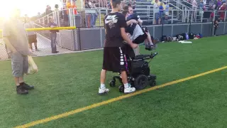 Young man in wheelchair rises for National Anthem