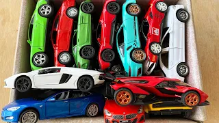 Box full of diecast cars, lamborghini v12, ferrari, bentley, supra, mercedes benz, porsche.