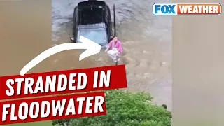 'You're Driving Into The Creek' Woman Drives Car Through Flooded Texas Creek, Climbs On Top Of Fence